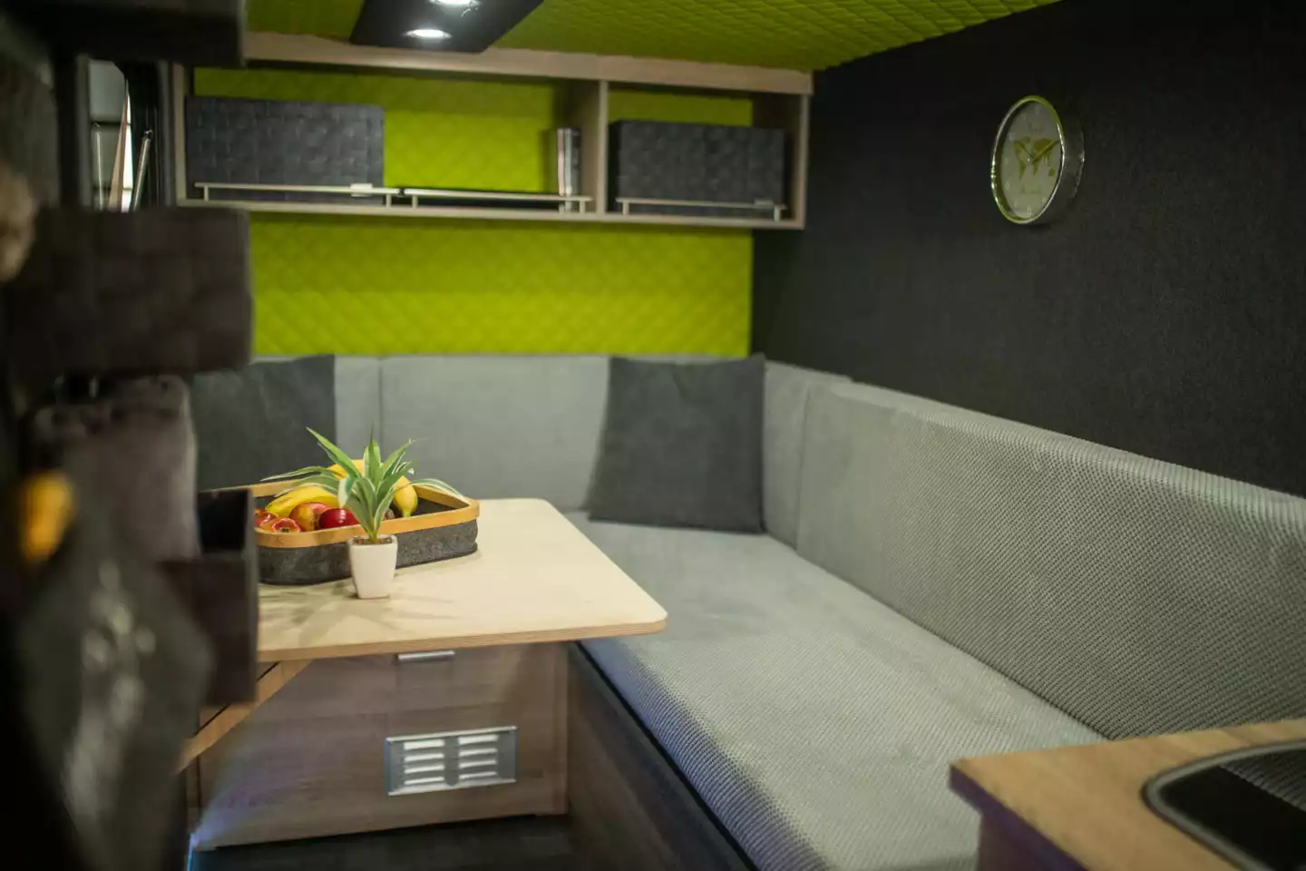 7even50 turns a box trailer into a miniature home with a combination of quilted and felt wall cladding, LED lighting, wood-veneered furniture and key living amenities,