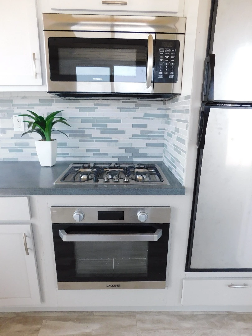 The Ozark's kitchen includes a four-burner propane-powered stove, oven, and microwave