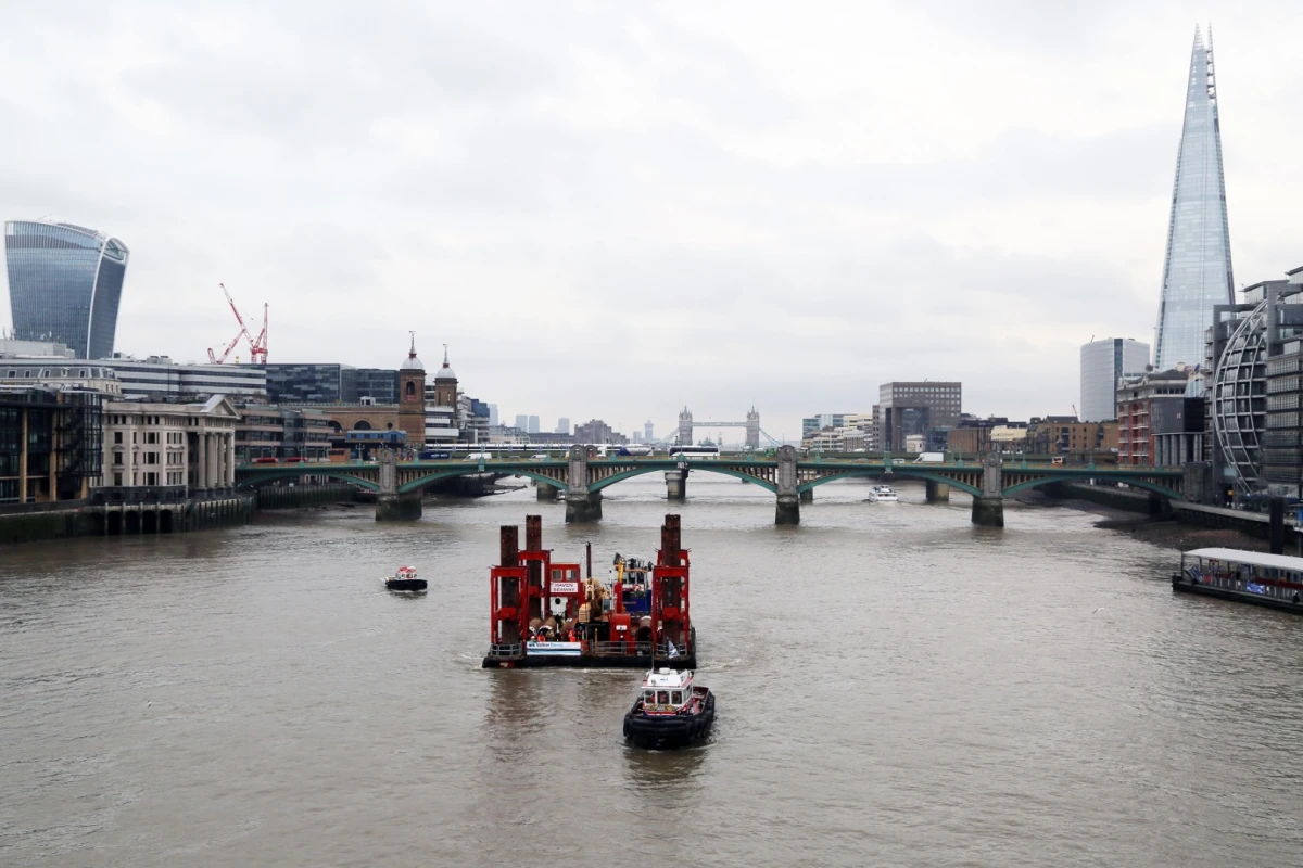 A crane has been moved into place at Blackfriars on the River Thames, signaling the start of work on the Thames Tideway Tunnel