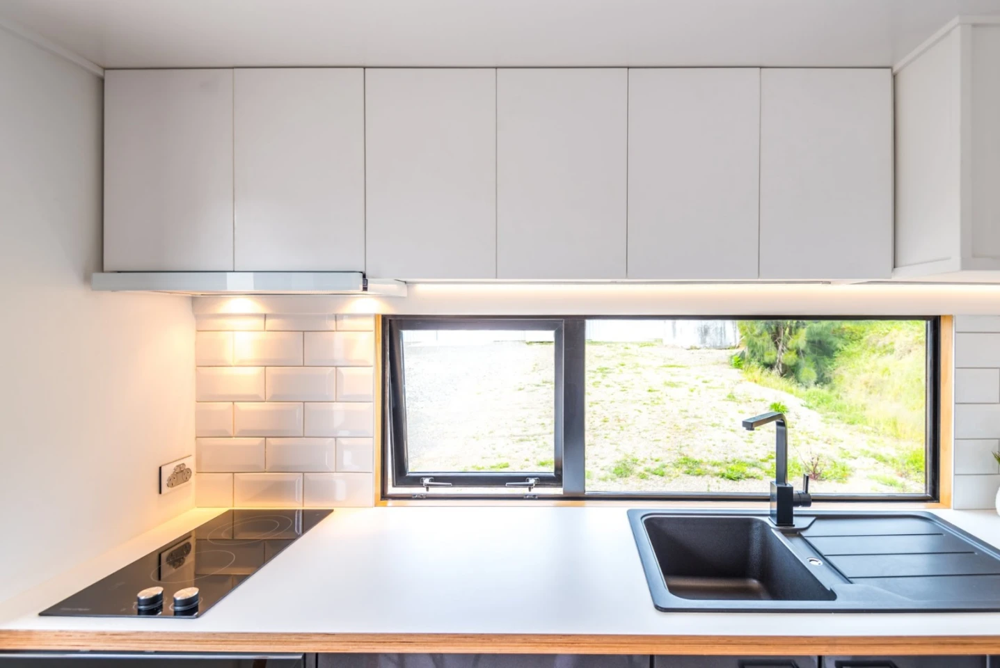 Overhead cupboards are featured in the kitchen for ample storage