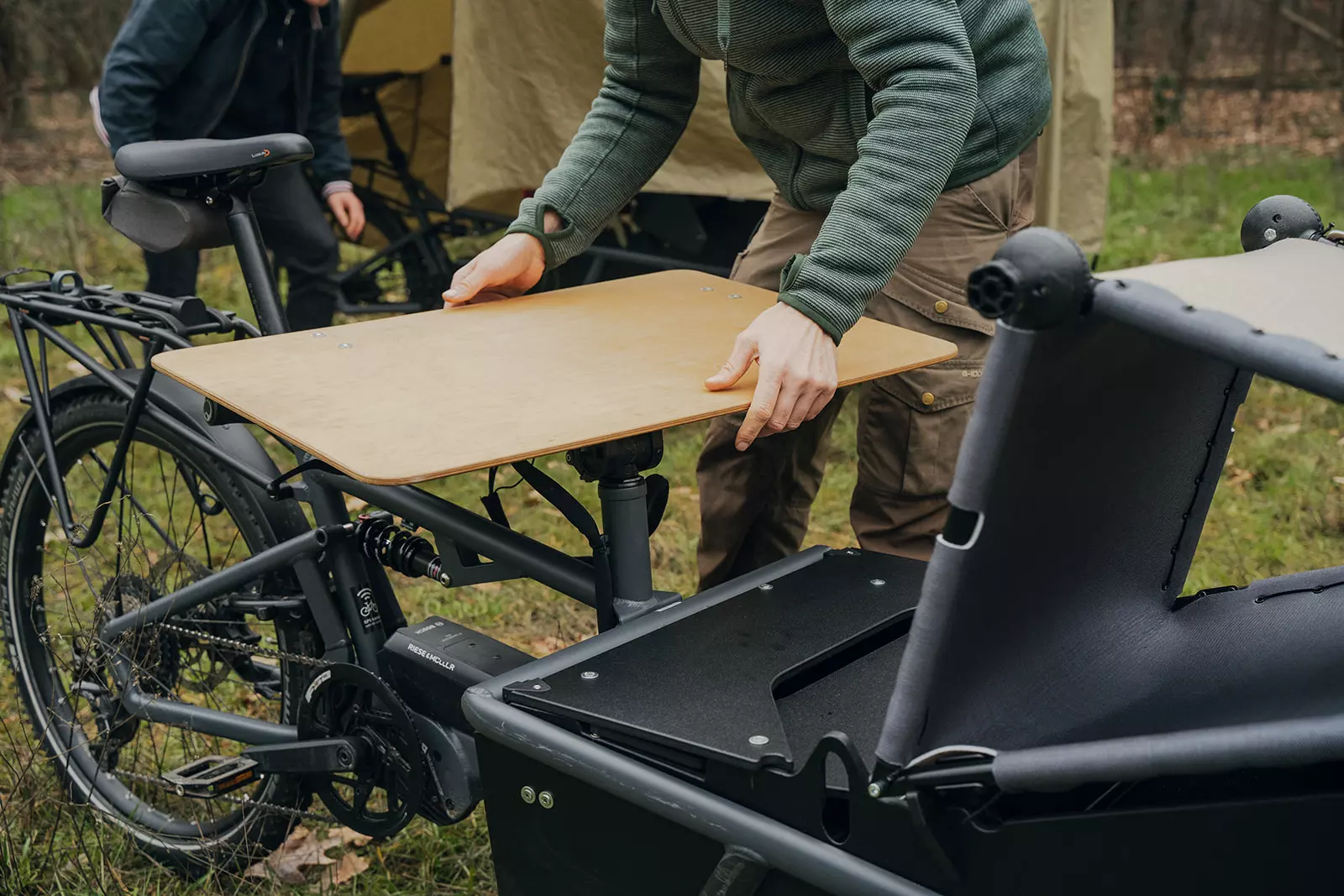 The tabletop sets up on top of the folded handlebars to become a dining table, desk and worktop