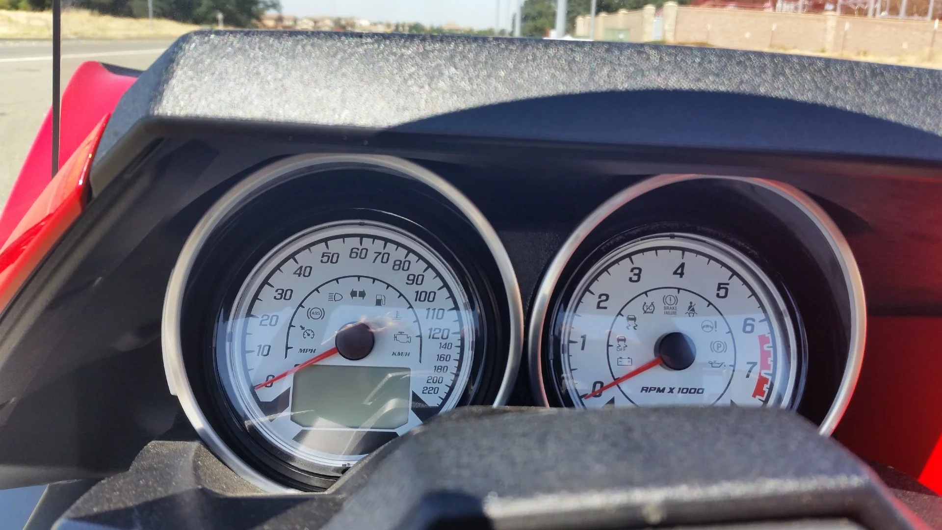The analog speedo and tach are easy to read, but the digital readouts are difficult if not impossible to see in the sun