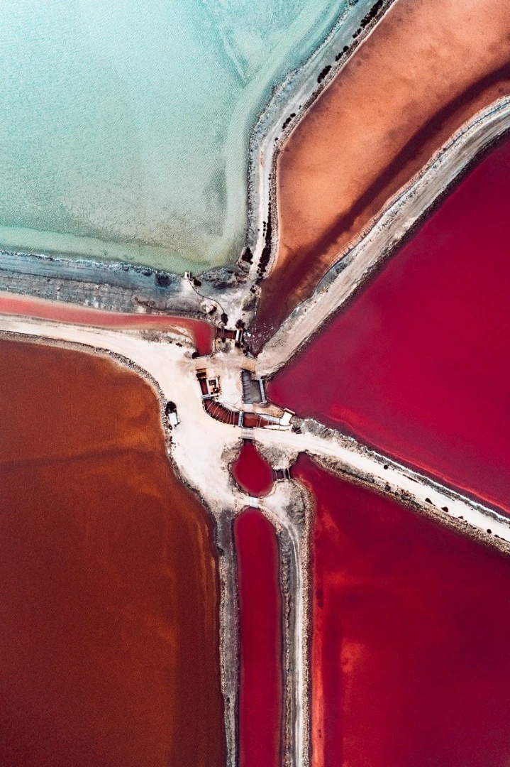 The Salt Series: Chronicling the harvesting of sea salt using artificially created ponds. The color of the water indicates the salinity of the ponds with micro-organisms changing their hues as the salinity of the pond increases