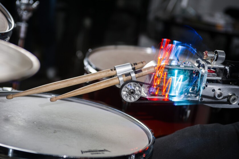 The prosthetic device is home to two drum sticks, one plays in response to sensor readings from the player's biceps, and the other "has a mind of its own"