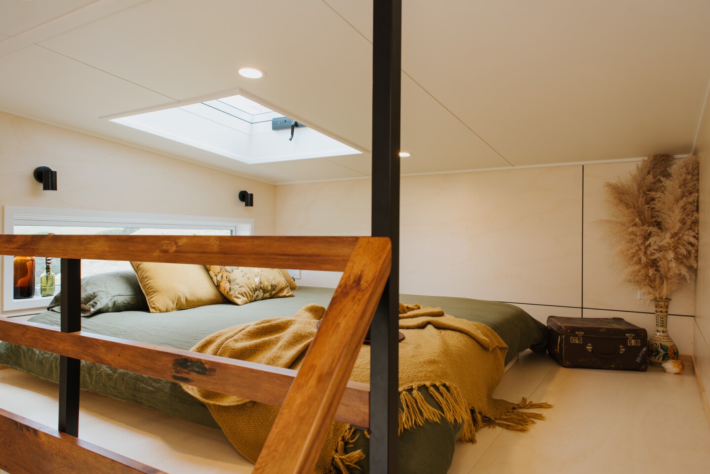 The Cherry Picker Tiny House's bedroom includes a king-sized bed