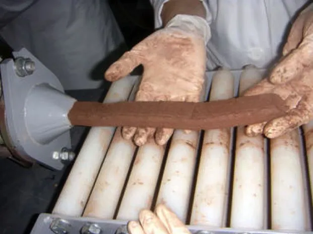 A length of the paper-based bricks being extruded