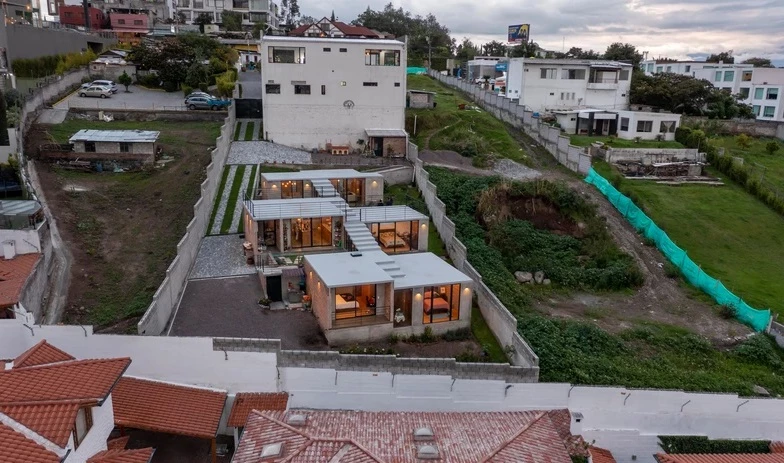 The home features three distinct structures that are adjoined via walkable rooftops