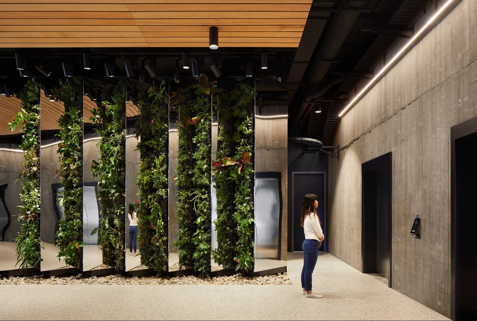 The entrance lobby at 25 king includes a greenery-covered wall