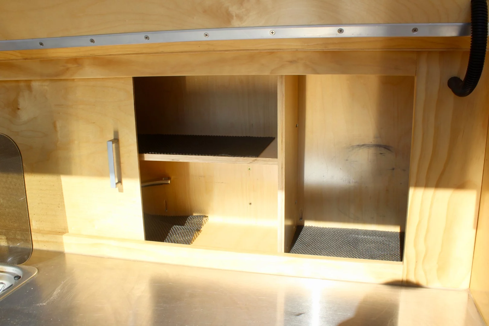 The 2018 Topo kitchen cabinet had sliding wood doors, but the new 2019 model has pull-off HDPE doors that double as other equipment