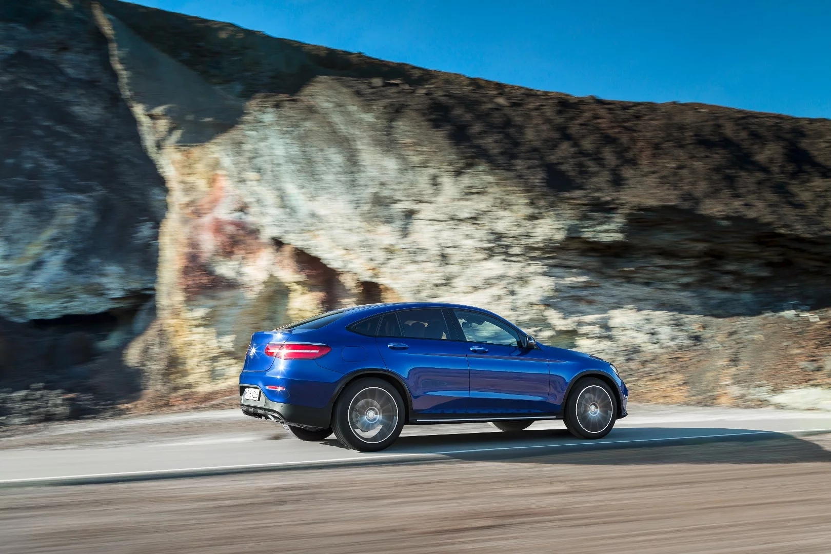 The car's rear lights are wide and slim to accentuate its width on the road