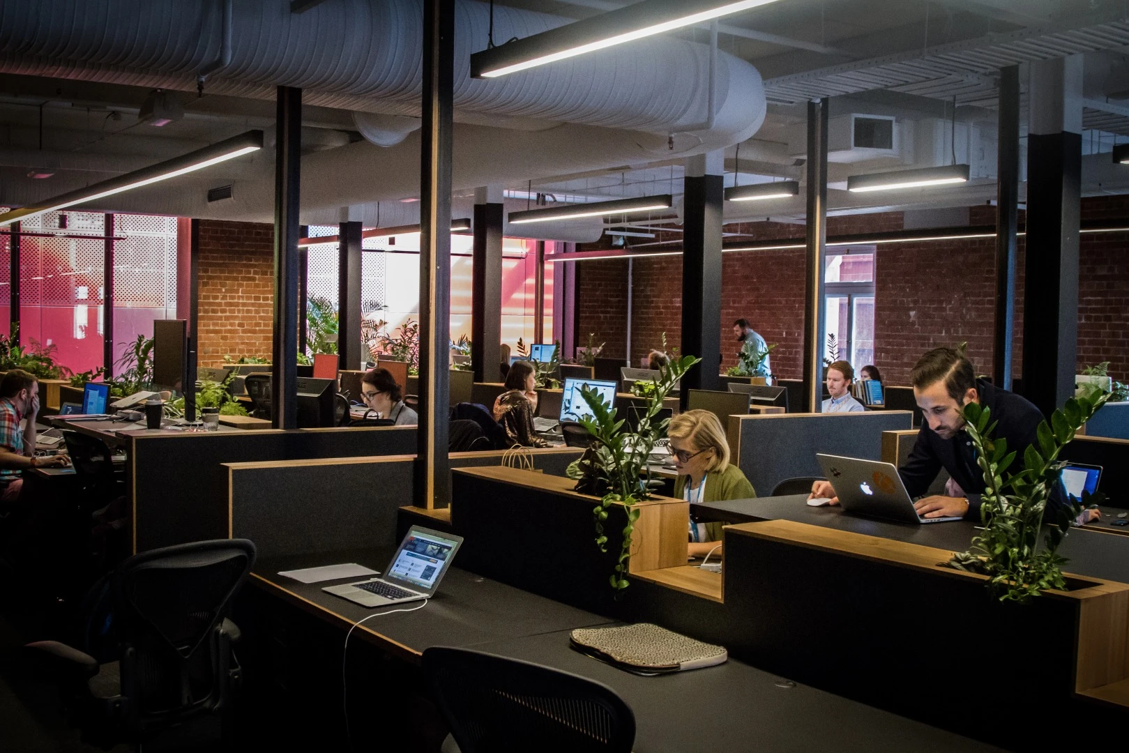 Rows of height adjustable desks fill the large open work area, nothing out of the ordinary here