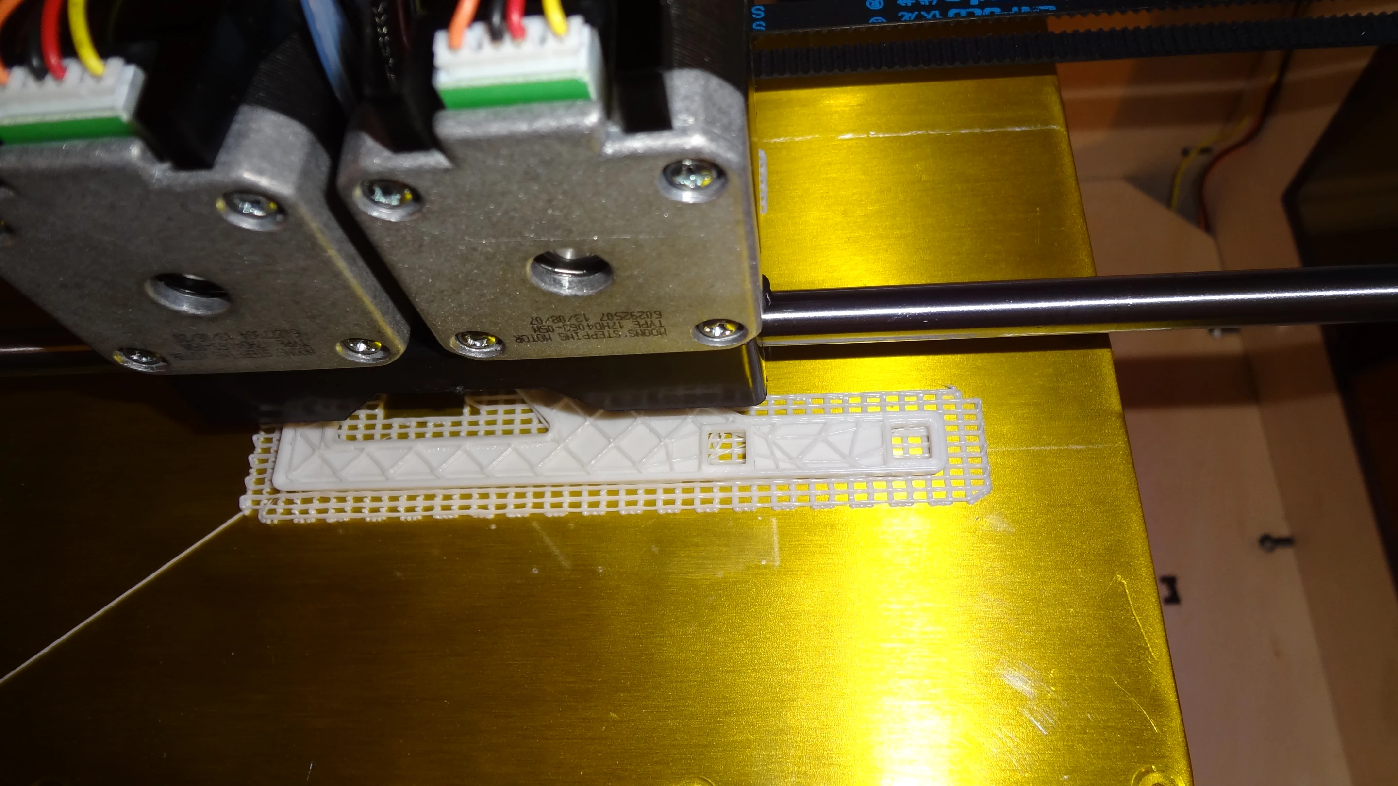 In this view, we see a model in process of being printed. Most 3D models are hollow, and the printer fills in the interior with these whimsical square shapes to provide strength and to give the top something to stick to (Photo: Gizmag)