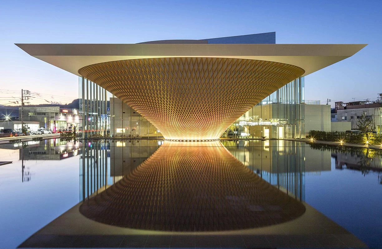 The upside-down pyramid that makes up the Mount Fuji Heritage Center is covered in an intricate timber lattice