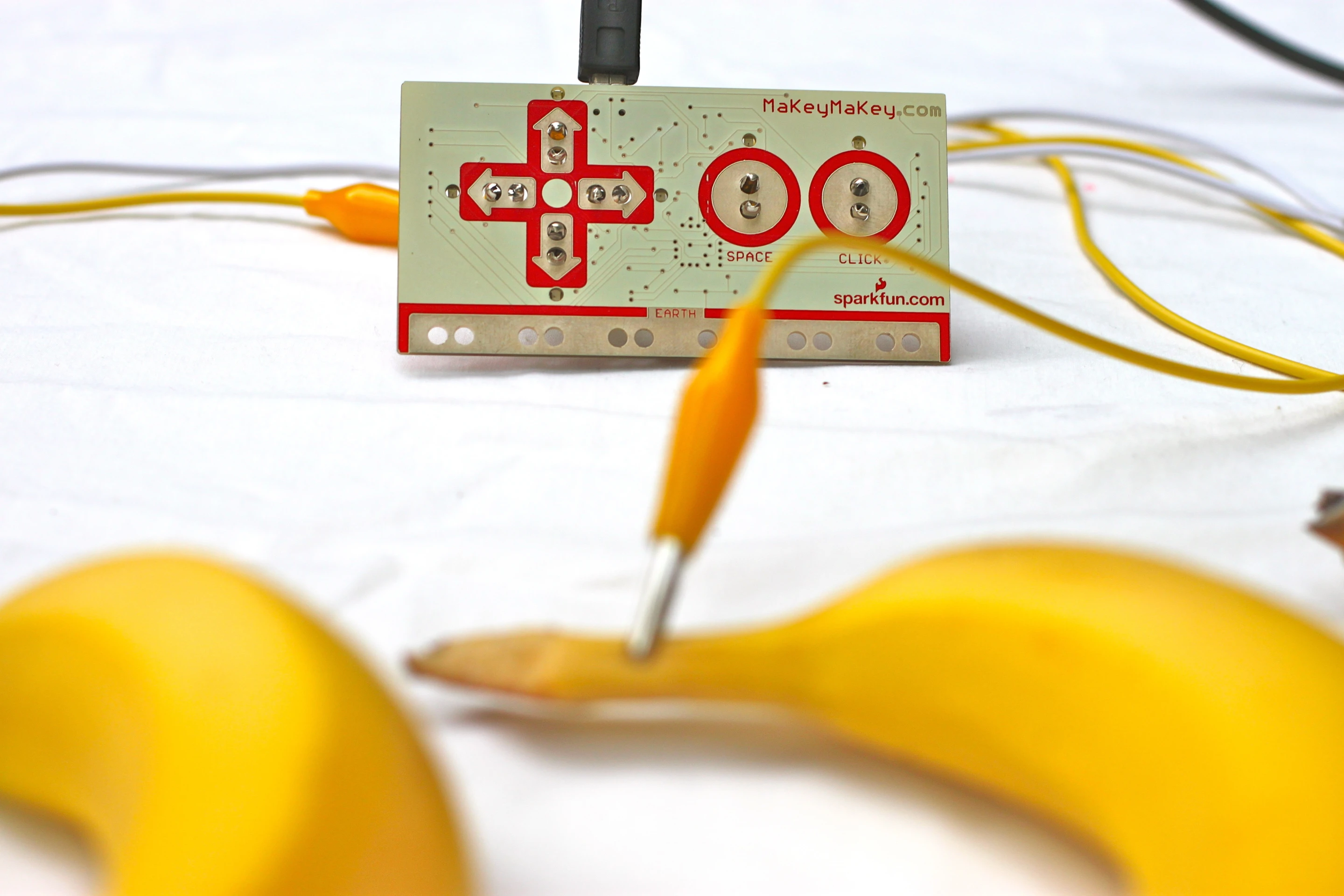 A banana can be mapped to a computer keyboard key or mouse click using Makey Makey
