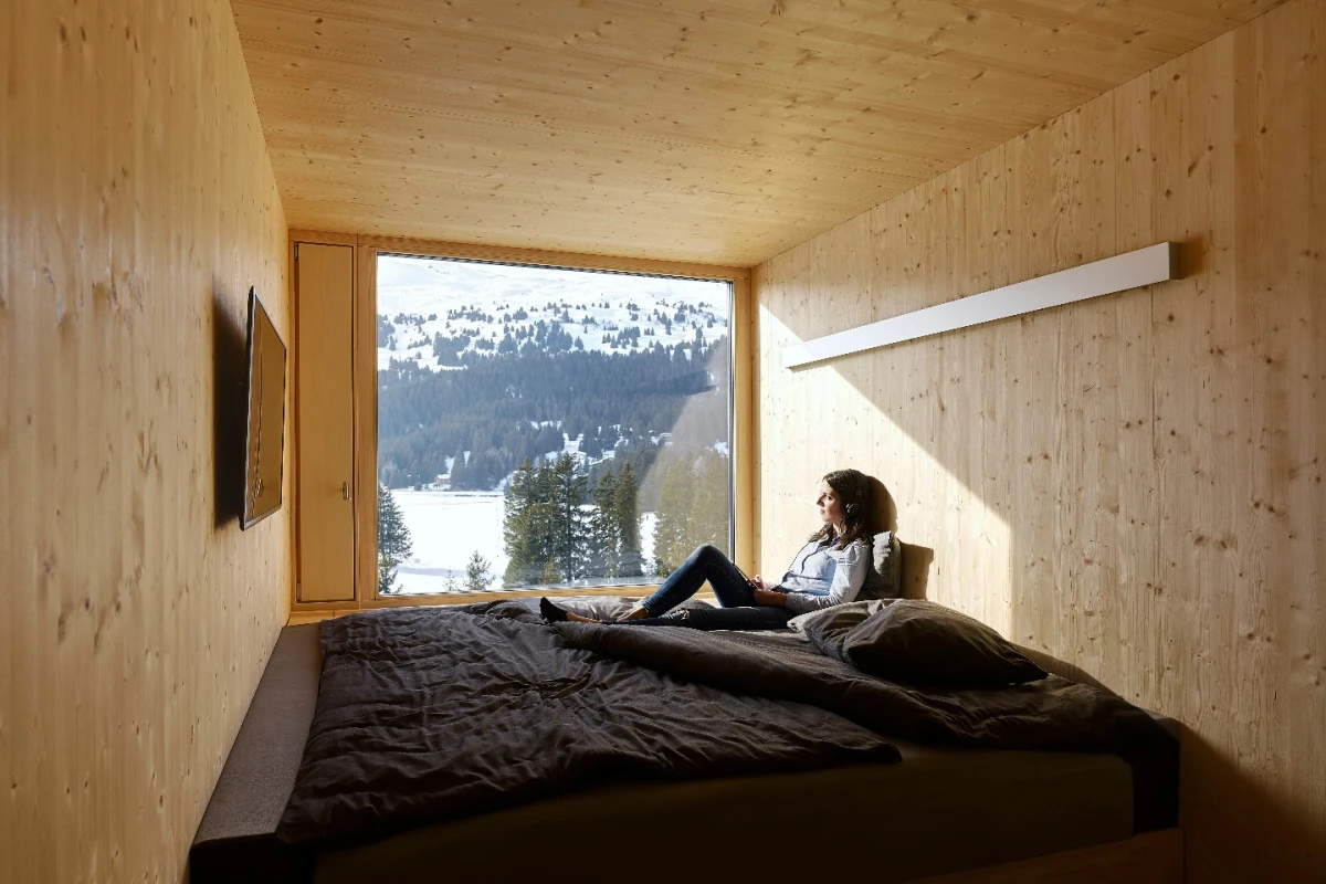 Each of the 96 rooms making up the four floors of the Revier Mountain Lodge was crafted from natural unfinished plywood and fabricated off site
