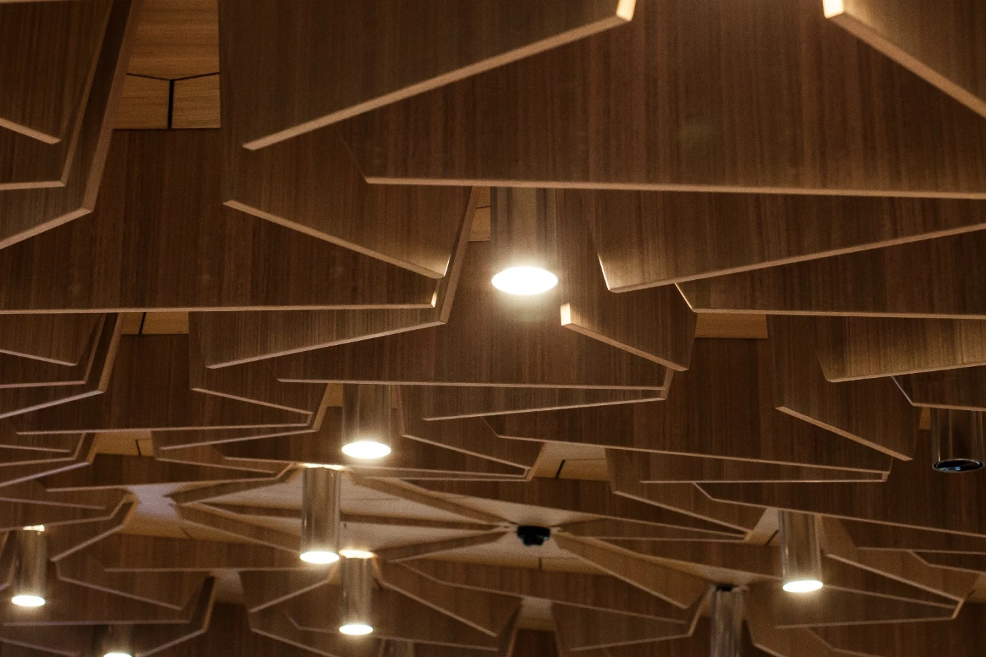 Under the base of the suspended studio are messy rows of vertical panels to further soften the acoustics