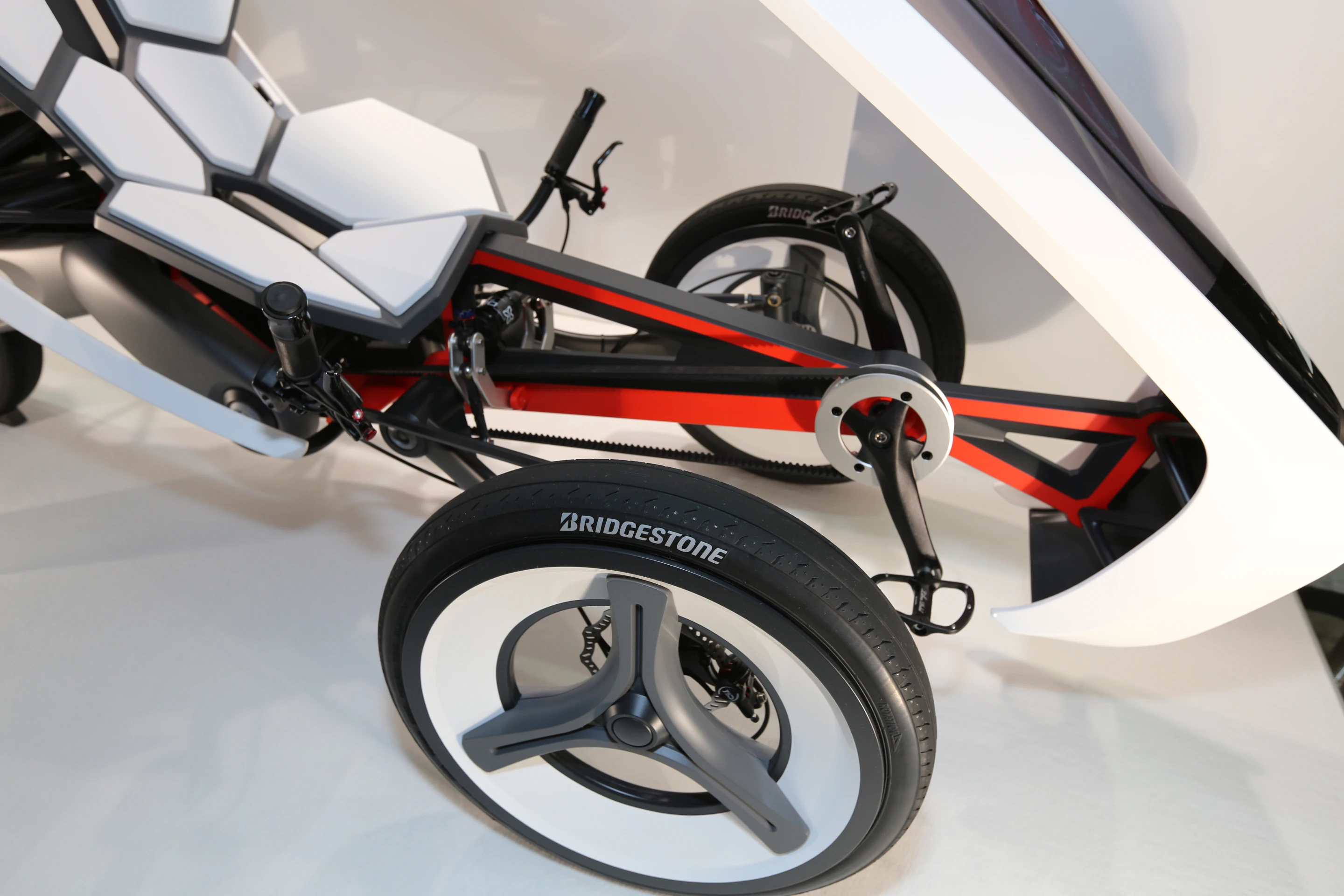 The trike utilizes a belt drive and disc brakes