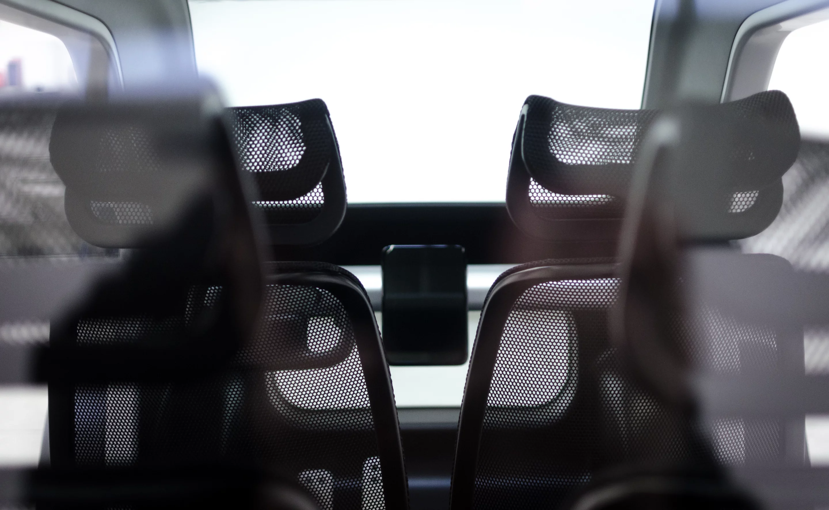 The Sin's interior is kept clean and simple, with a rectangular steering "wheel" and tablet-like display, and mesh seats for the driver and three passengers