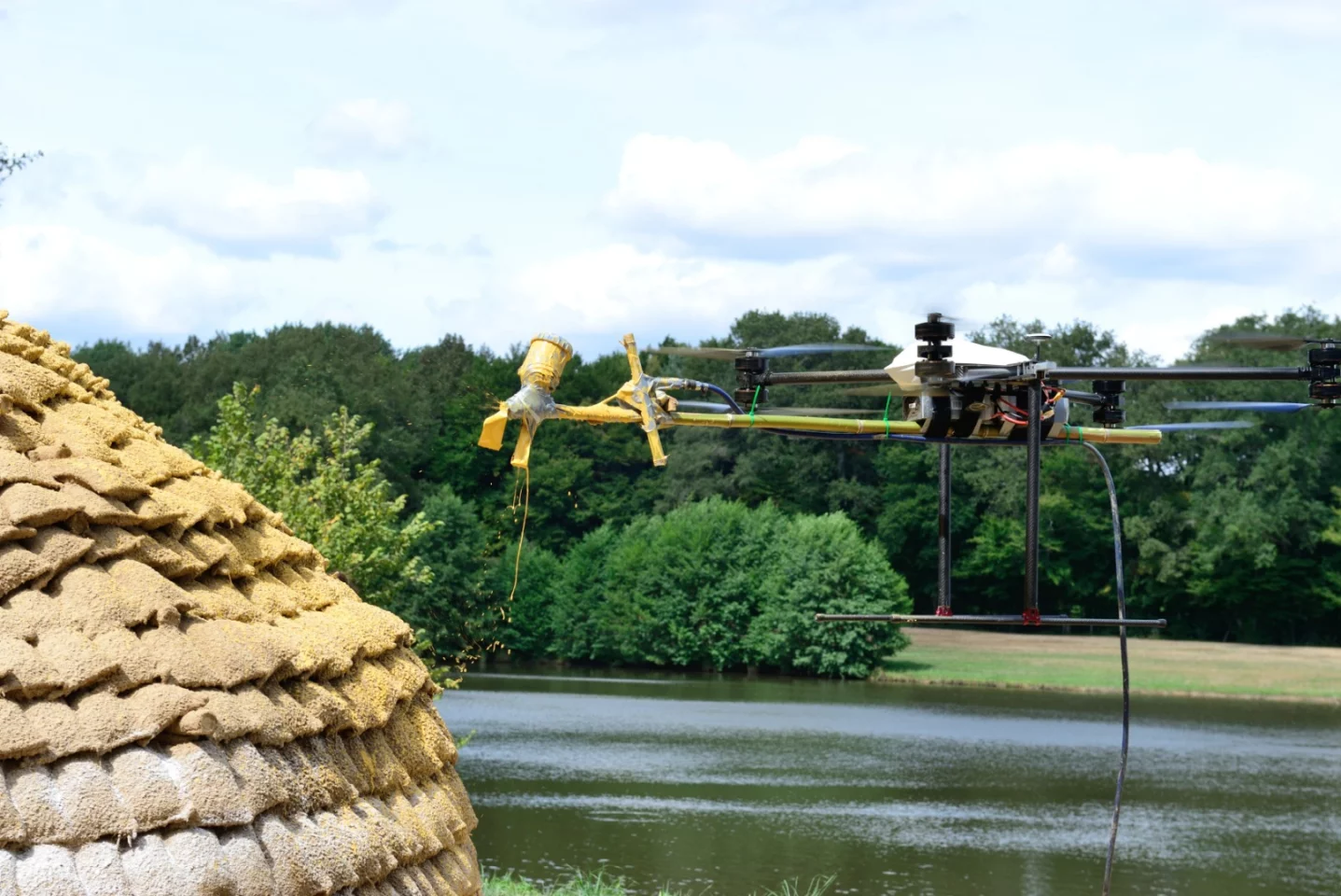 A drone applies the exterior finishing to dome shelter