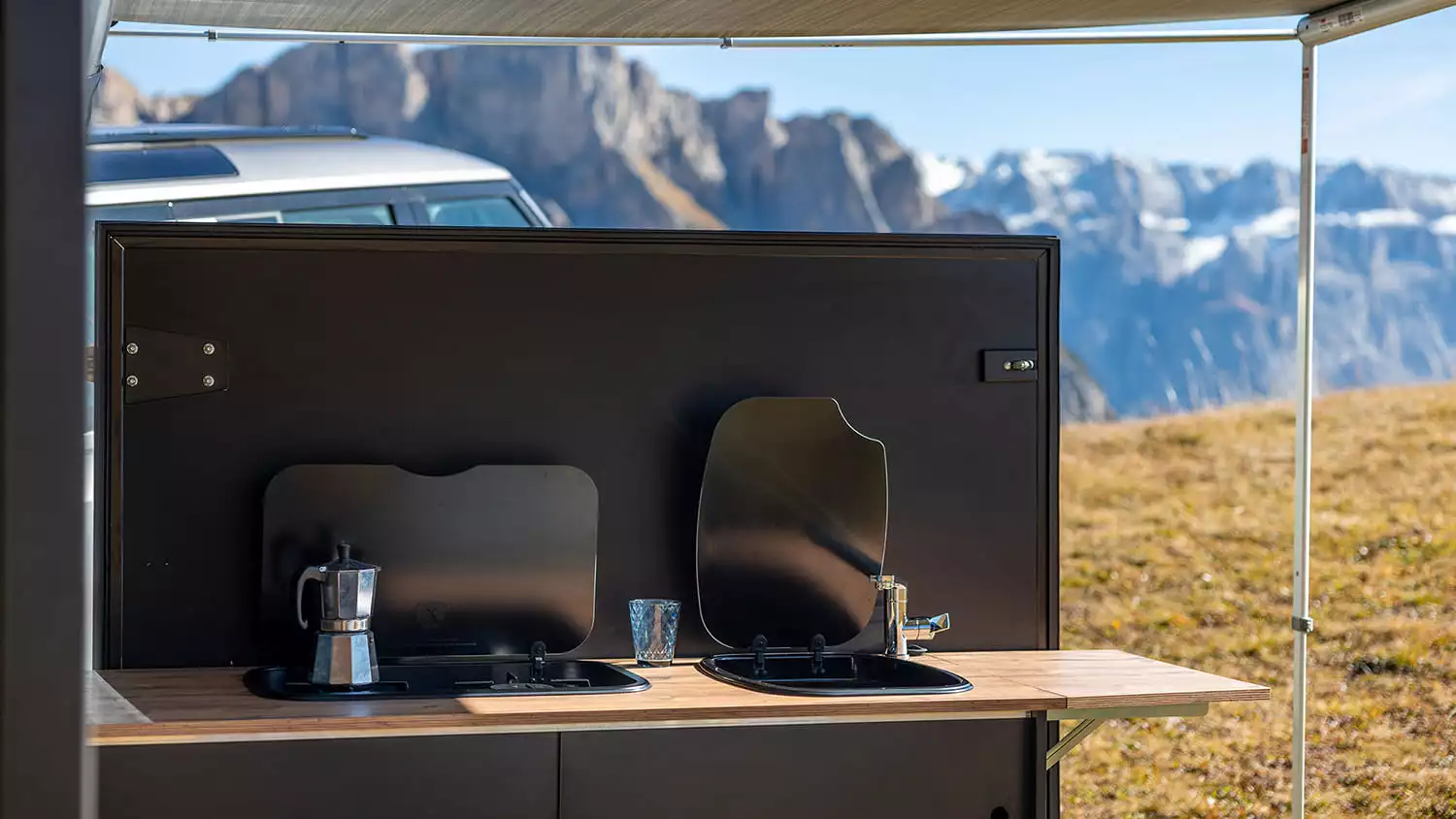 Both the stove and sink have lids for neater storage and added workspace