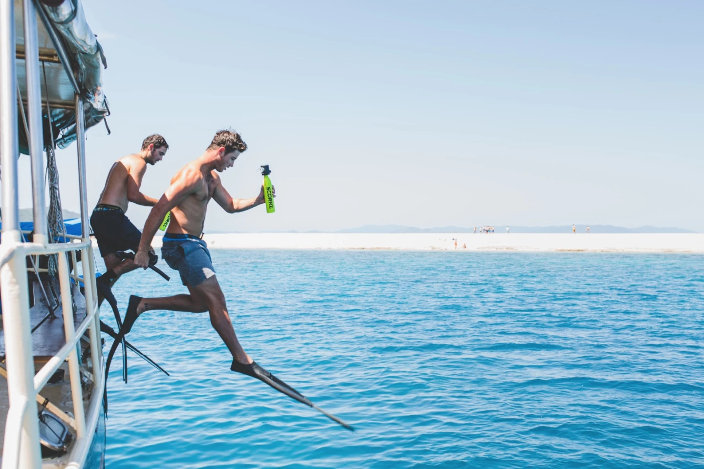 A couple of divers get ready to head underwater with the Scorkl in tow