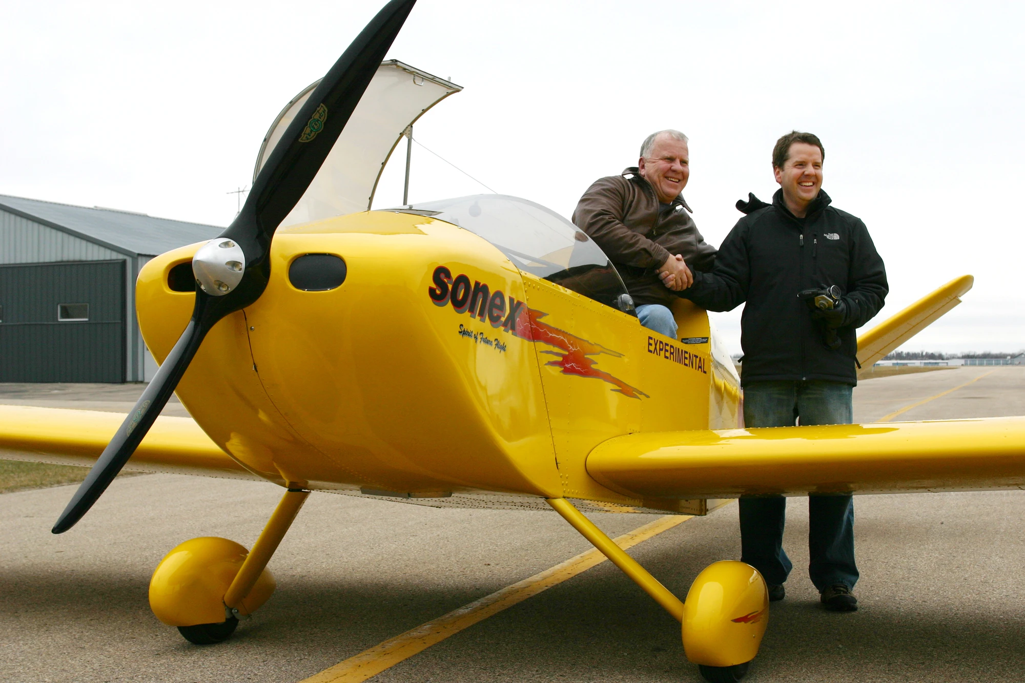 John Monnett (left) and Jeremy Monnett (right) celebrate the successful maiden flight