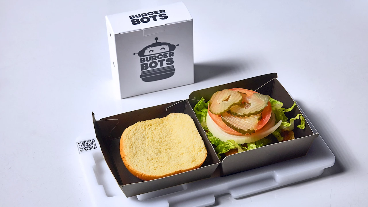 BurgerBots final assembly: an $18 burger, still in its QR-coded tray