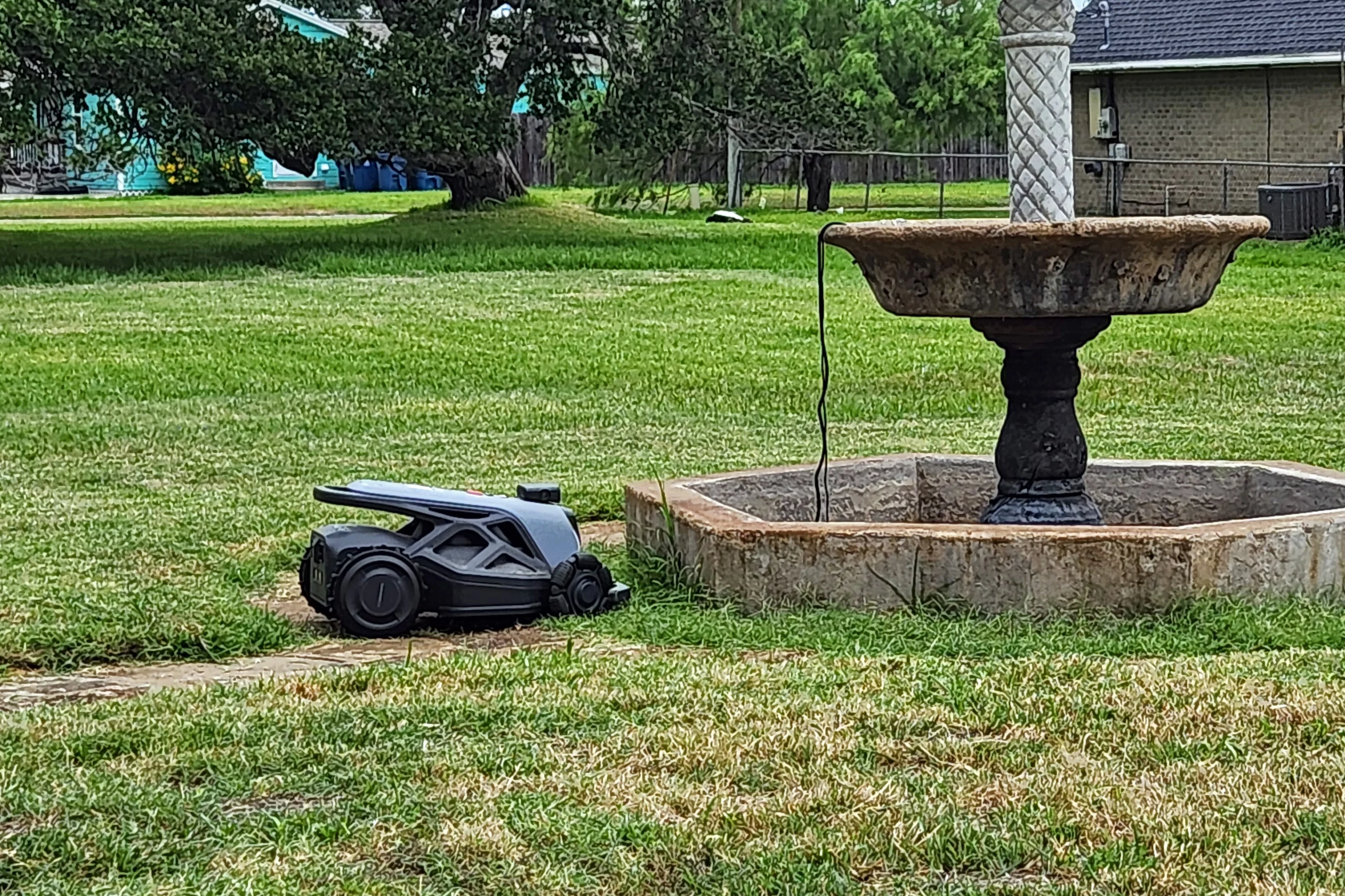 I kid you not, twice in a row, the Tron ended up in this exact same spot, both times having crashed into the fountain repeatedly before it simply shut down. On the plus side, the Tron is physically bigger than all the other mowers I've testedd, it's hands down the EASIEST robomower to carry, as it has a huge handle on the back, and a decently big one on the front.
