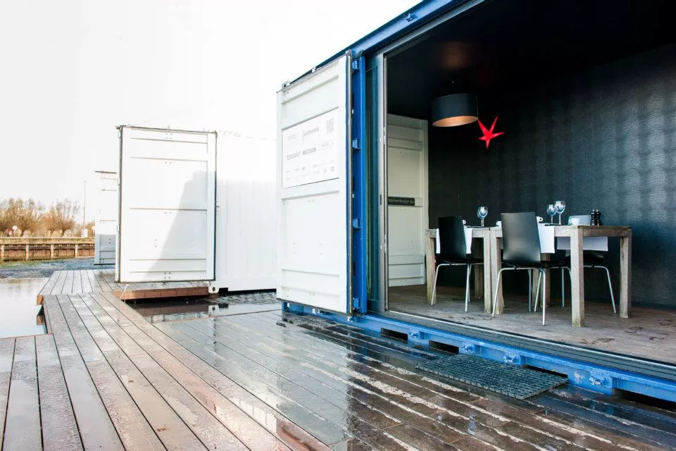 The lounge container is setup like a breakfast nook for guests to enjoy a cup of coffee or glass of wine together