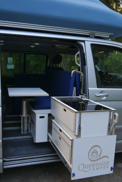 At night, the table slides and drops, teaming with the kitchen to support the bed
