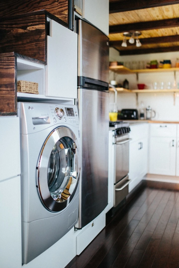The stairs also include a washer/dryer, fridge, and cupboard space