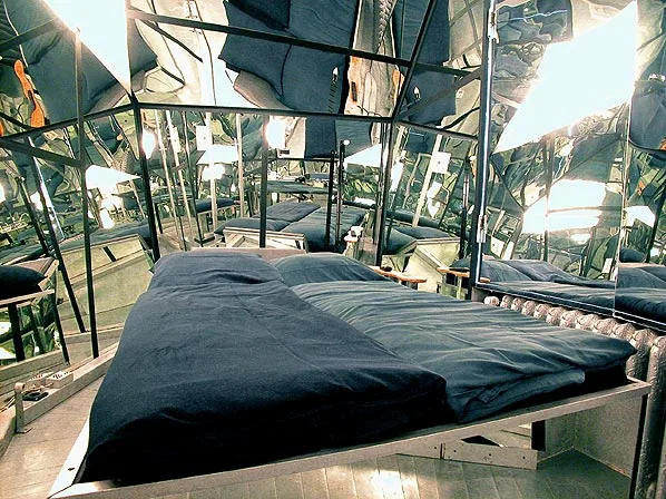 The Mirror Room is laid out in a diamond shape and the central bed is completely surrounded by mirrors
