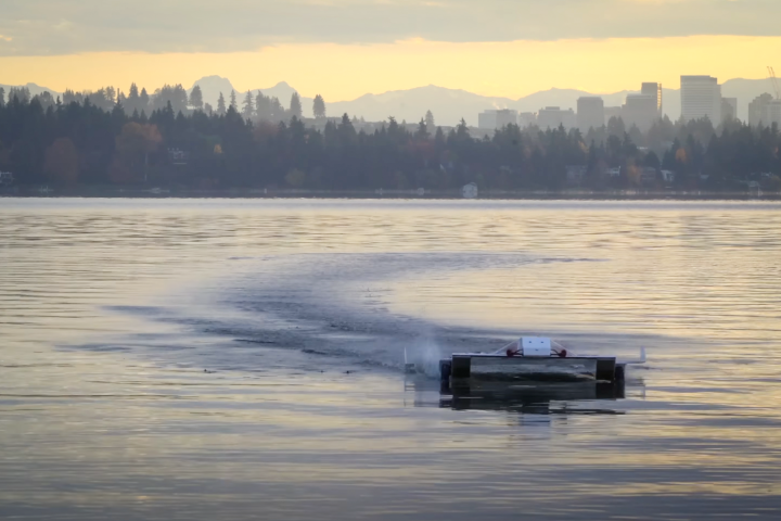 A ground effect vehicle skims the surface of the water, with paddle wheels to counteract a dangerous increase in drag