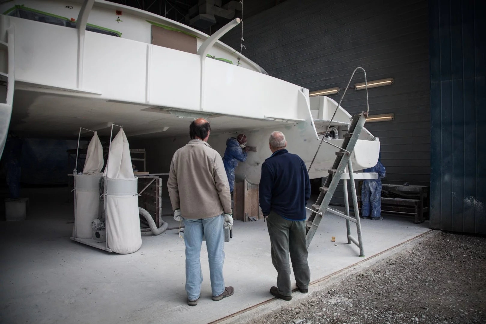Wopper watches over a catamaran under construction at his boatyard