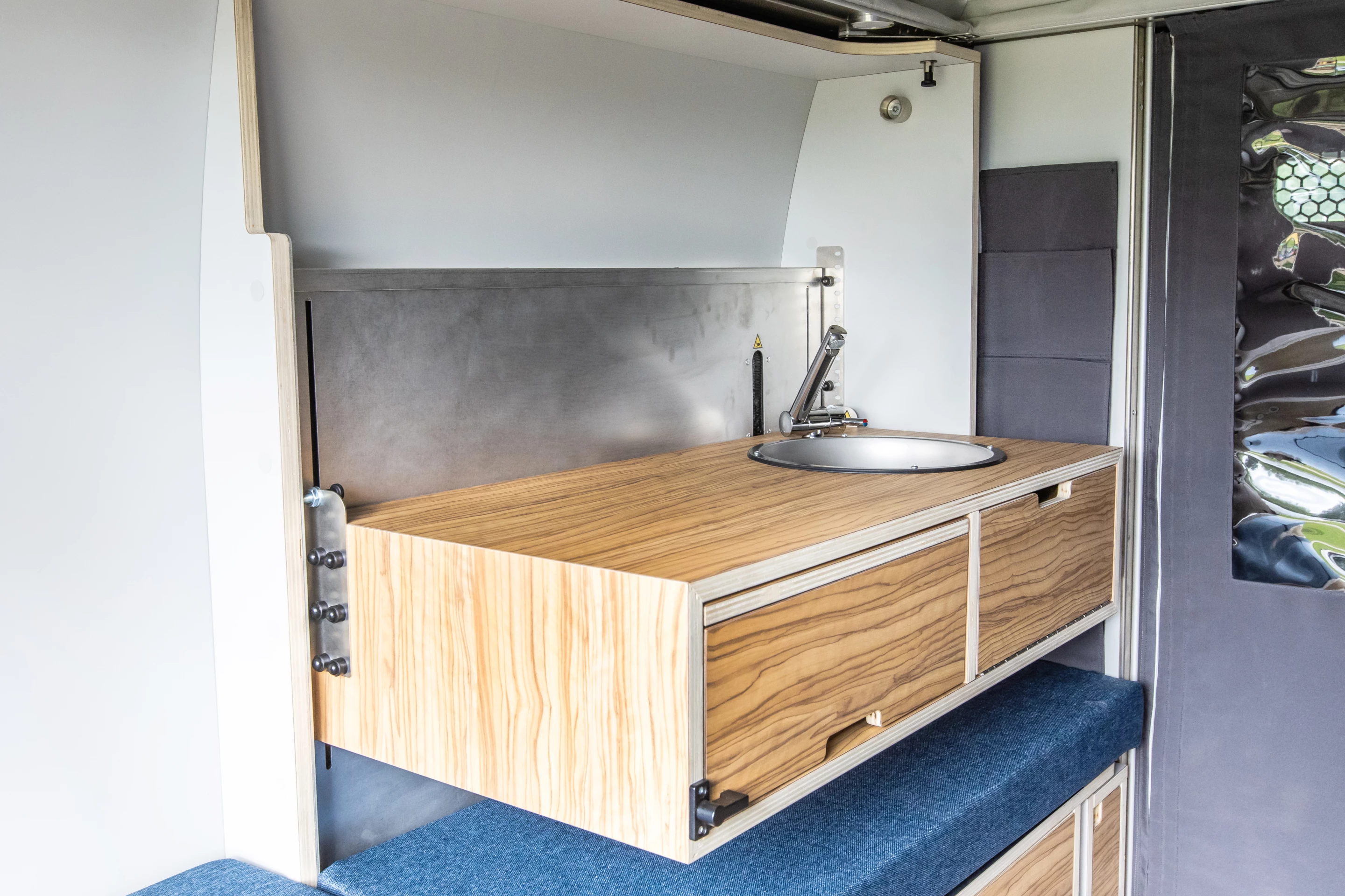 PlugVan's versatile kitchen lifts up, slides out and expands for different uses