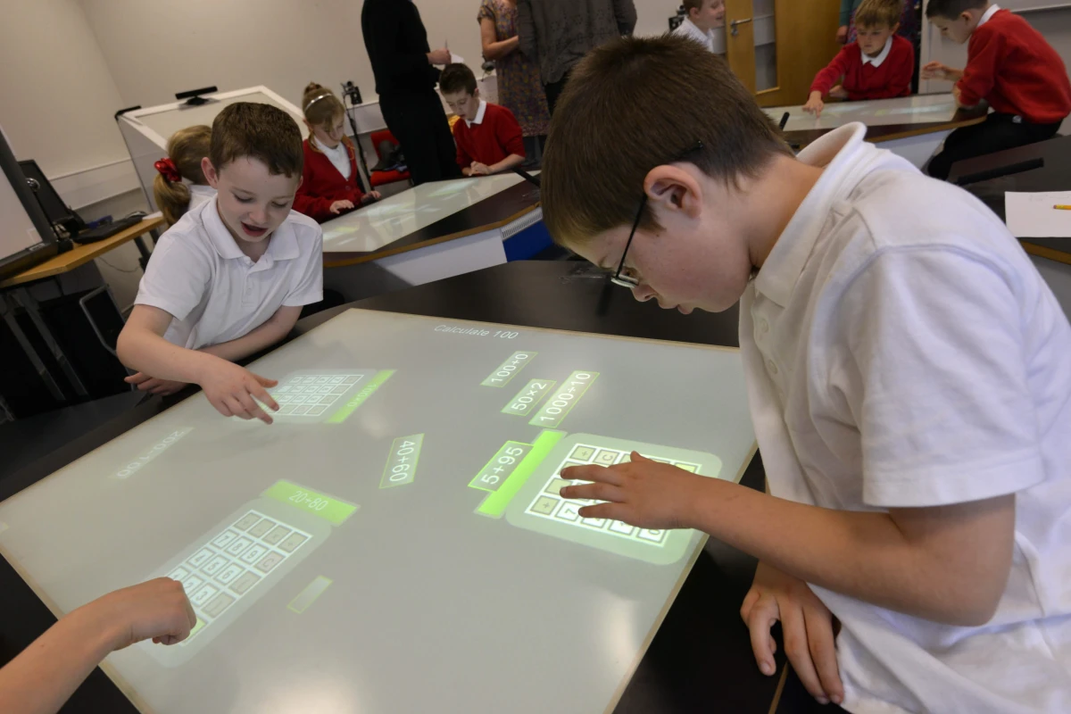 Students using the SynergyNet project's NumberNet desks