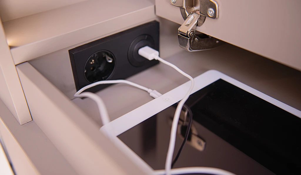 Hideaway compartments in the 7.0 Lounge media console offer mobile device storage and charging