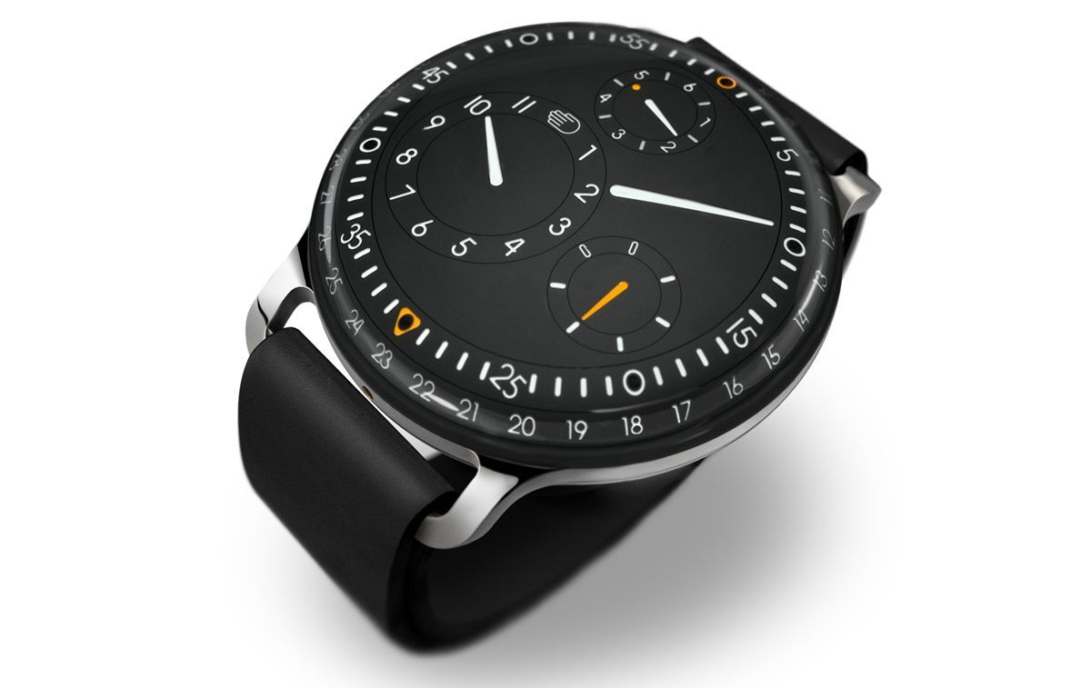 Separate mechanical dials indicate hours, minutes, seconds, AM/PM and date