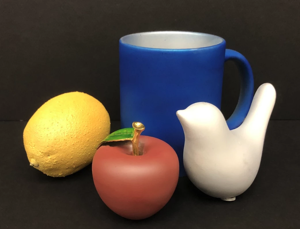 A series of objects painted with the new infrared-blocking paint, showing off the range of colors it can come in
