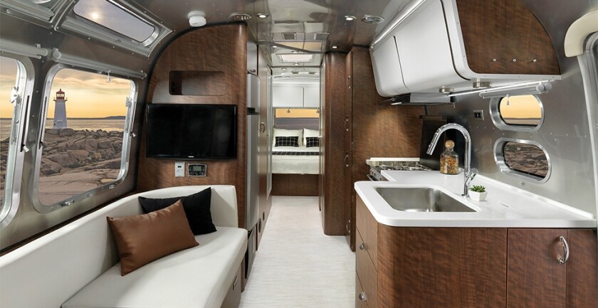 The Airstream Globetrotter's lounges pull out for extra bedding and are covered in finely woven, stain resistant fabric