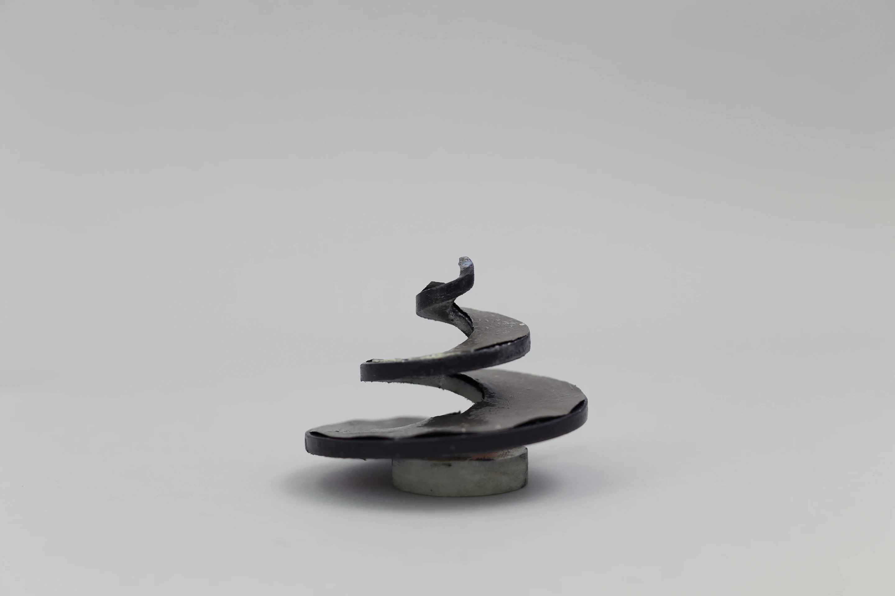 Prototype of a 3D-printed abstract spiral loudspeaker, that emits sound off its spiral surface (Photo: Disney Research)