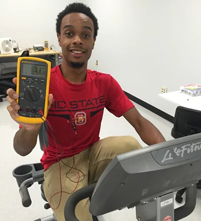 NCSU's Haywood Hunter demonstrates the team's t-shirt-embedded thermoelectric generator