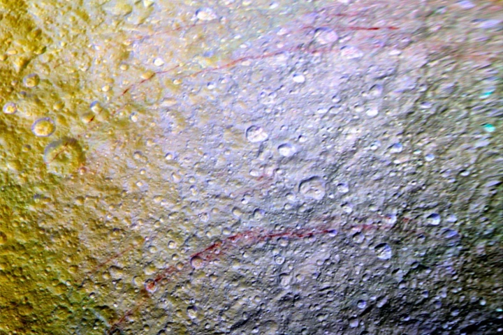 Strange reddish streaks mark the surface of Tethys in this mosaic image