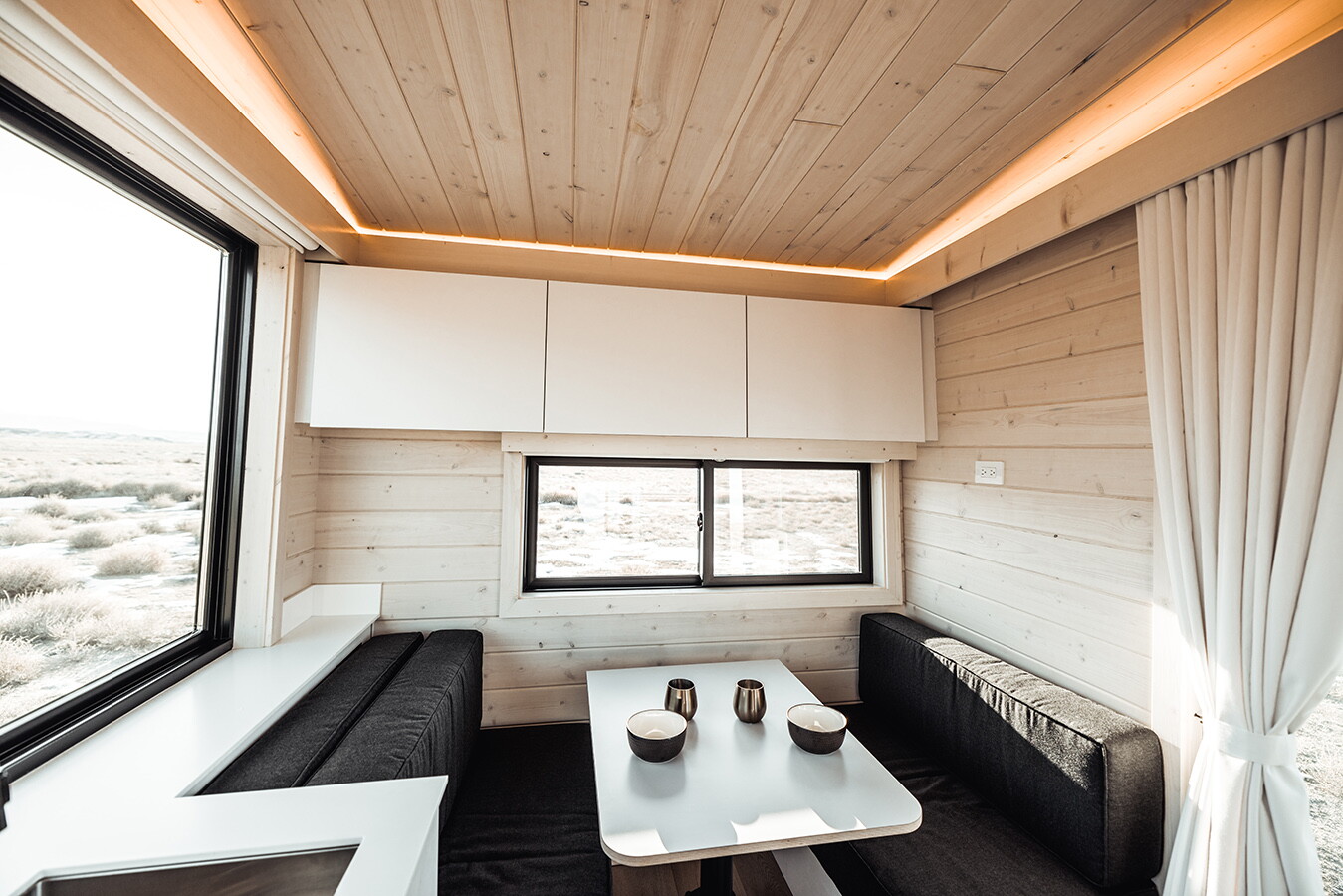 The Quatro's main living area includes a dining table and seating that transforms into a double bed for guests