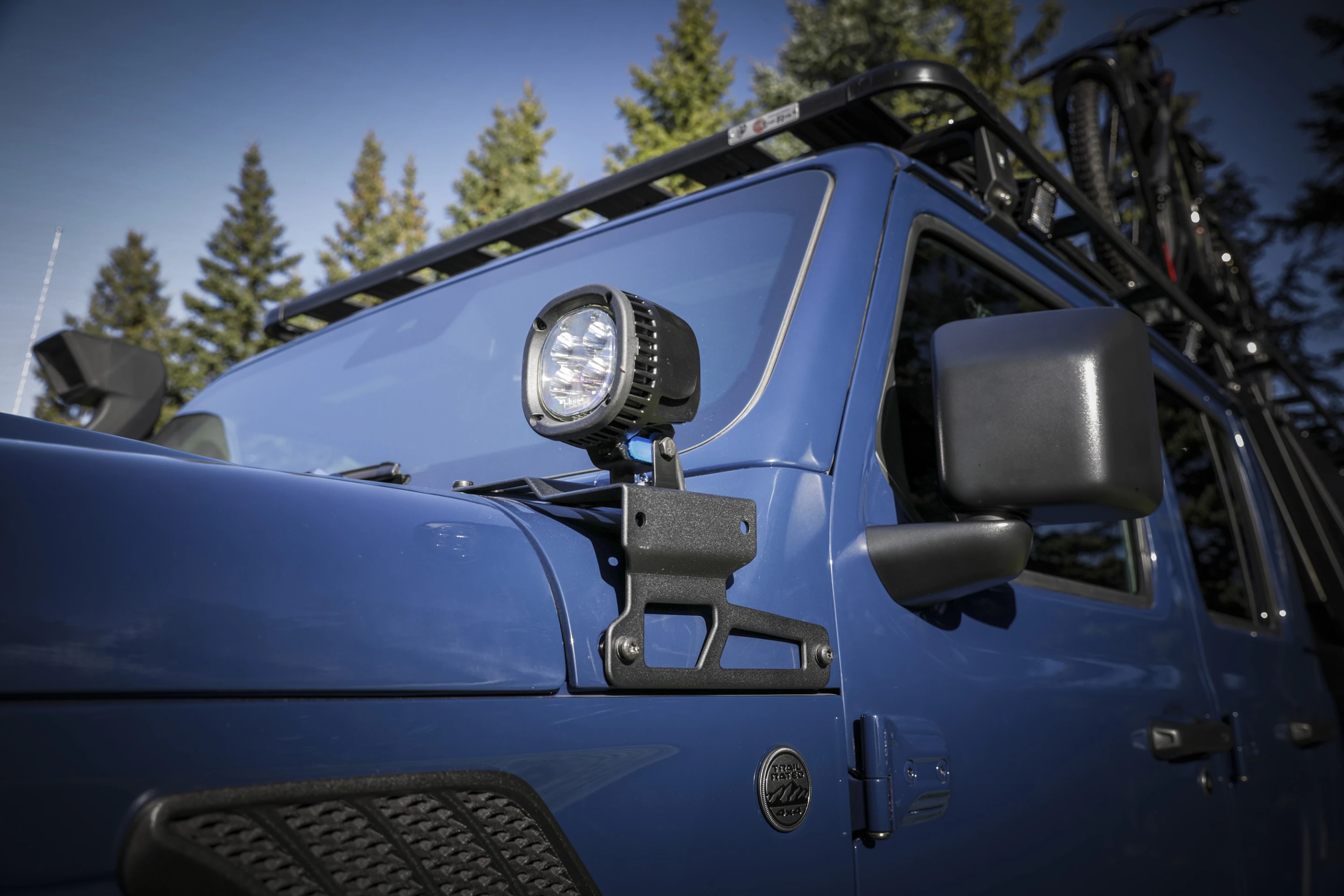 Off-road auxiliary lights are installed at the base of the A-pillars