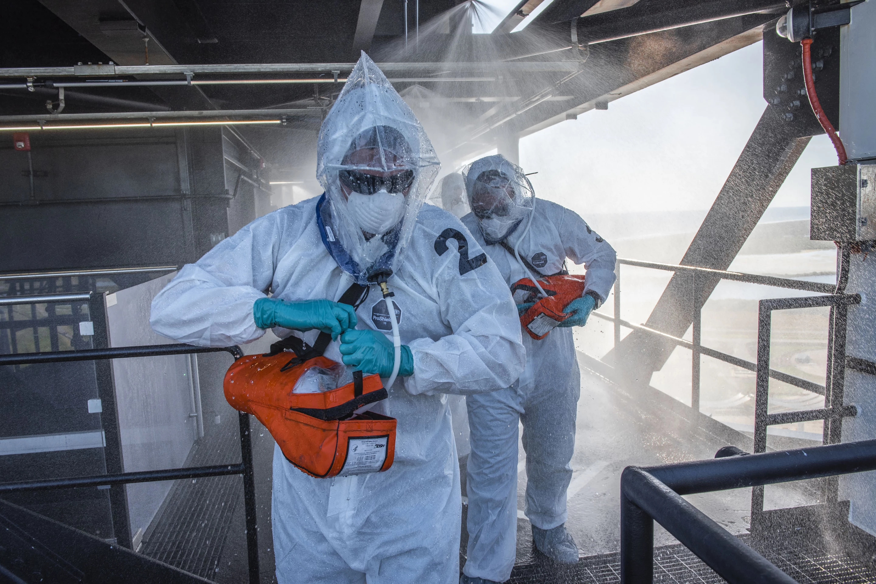 Ground crew in protective gear practicing escape procedures