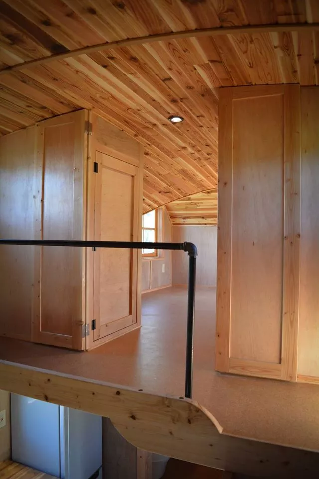 The entrance to the bedroom is flanked by a pair of large closets