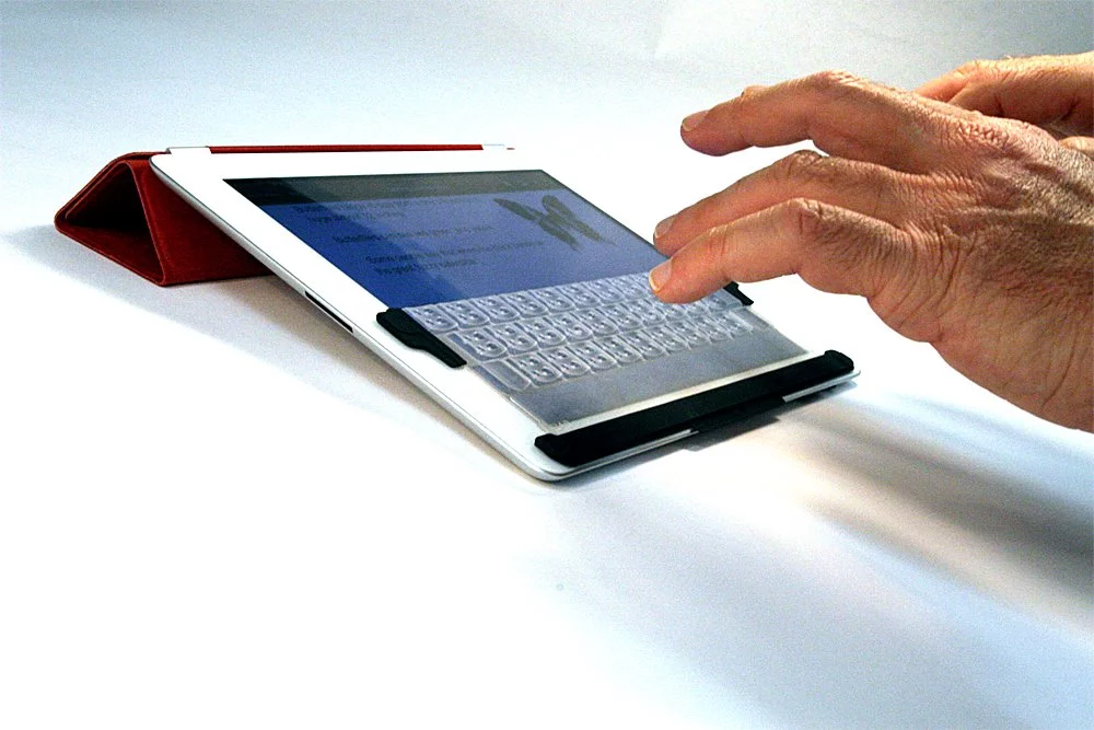 TouchFire - useful for typists who need more tactile fingertip feedback than the iPad's virtual keyboard can provide