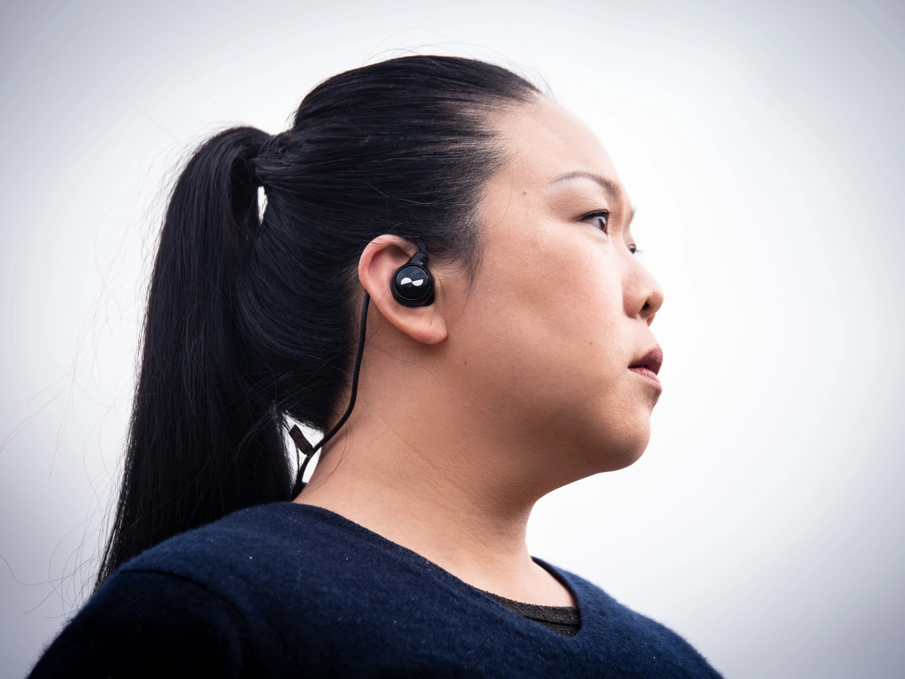 The loop behind your neck can foul collars and hoodies, sometimes feeling like it'll push the earbuds out, but the problem largely goes away when you bend the ear hooks to hold your ears more securely