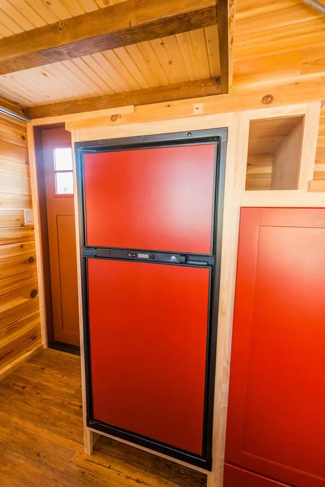 The kitchenette in Davis's 22 ft Off-Grid Tiny Home includes an efficient fridge that can run from propane or electric